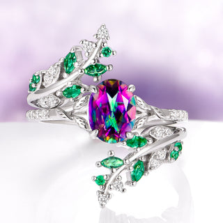 Elegant ring with a colorful gemstone and green gemstones on a light purple background