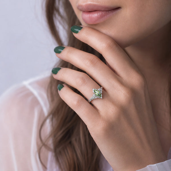 Viridian Marquise Green Tourmaline Engagement Ring by Aquamarise, worn on the hand against a soft white top.