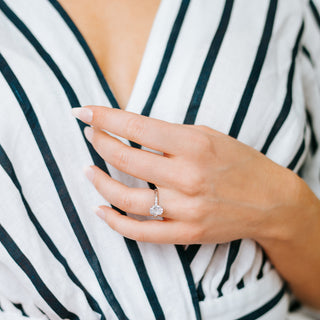 Hand wearing an oval moissanite filigree engagement ring by Aquamarise