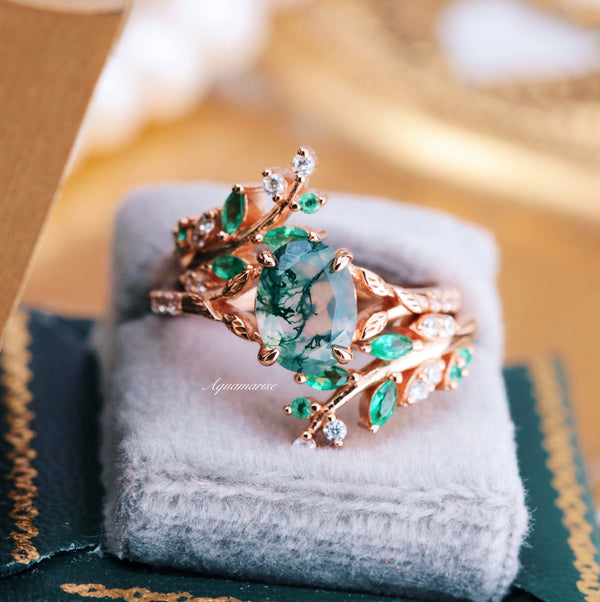 Green Moss Agate Leaf Engagement Ring in 14K Solid Rose Gold by Aquamarise Gold, featuring a marquise-cut moss agate center stone accented by emerald and diamond leaf motifs, displayed on a soft gray cushion.