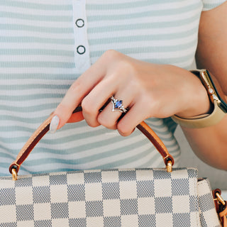 Kite Alexandrite Ring Set- Sterling Silver by Aquamarise, featuring a kite-cut alexandrite gemstone with delicate silver accents, shown on a hand holding a checkered handbag.