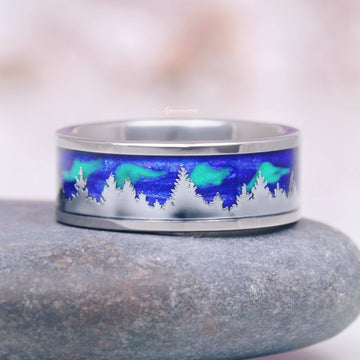 Aurora Borealis Forest Couples Ring Set- Northern Lights & Trees featuring a polished band with an engraved tree silhouette against a vibrant blue and green aurora background by Aquamarise, part of Matching Couples' Rings and Nature-Inspired collections.
