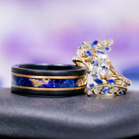 Lab-Grown Diamond & Sapphire Leaf Engagement Ring Set in 14K Solid Yellow Gold (IGI Certified) alongside a black tungsten band with blue sapphire and gold leaf inlay by Aquamarise Gold.