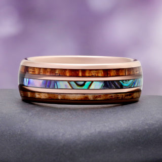 Close-up of the iridescent abalone shell and wood inlay