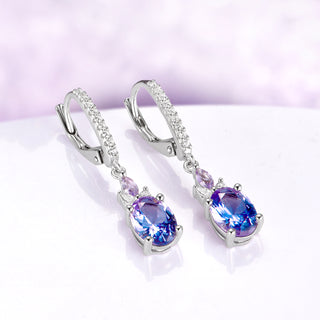 Alexandrite Earrings Oval Color Changing Alexandrite over light purple background