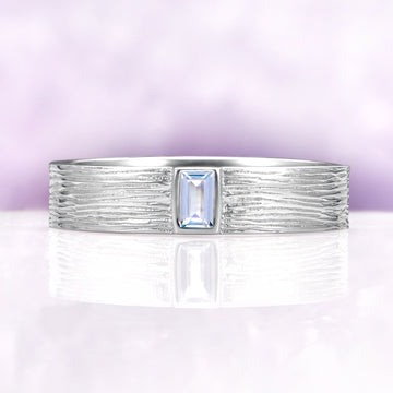 Celtic Aquamarine Couples Ring Set by Aquamarise featuring a textured sterling silver band with a rectangular aquamarine center stone, ideal for matching couples rings and meaningful gifts.
