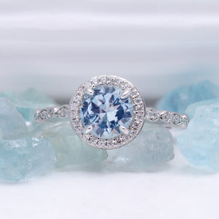 Art Deco Aquamarine Engagement Ring by Aquamarise, a round aquamarine in a diamond halo, styled on raw aquamarine crystals.