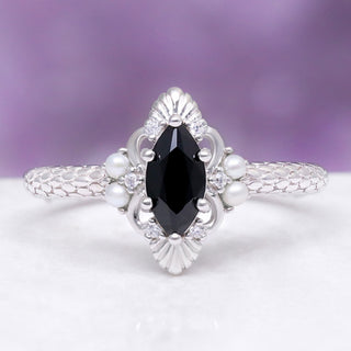 Arwen Black Onyx & Pearl Couples Ring Set by Aquamarise, featuring a marquise black onyx center stone with pearl and diamond accents on a detailed sterling silver band.
