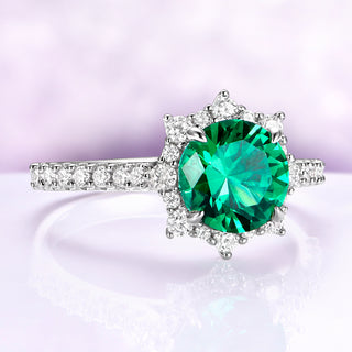 Emerald Engagement Ring Round Emerald Halo Ring over light purple background 
