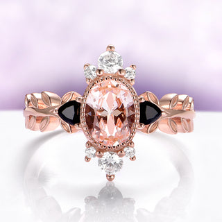 Aurelia Morganite & Black Onyx Leaf Engagement Ring in 14K Solid Rose Gold by Aquamarise Gold, featuring an oval morganite center, black onyx accents, white gemstones, and a leaf-inspired band design.