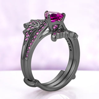 Side profile of the trillion pink sapphire center ring nested between the two wings of the black ruthenium wrap band