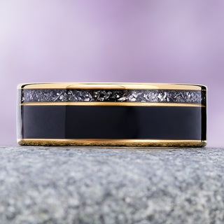 Black onyx and meteorite men's wedding band in yellow gold tungsten, 8mm, wide onyx inlay below a narrow meteorite channel between gold rails
