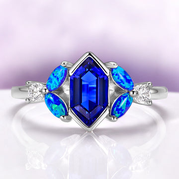 Hexagon Sapphire Blue Opal Engagement Ring in Sterling Silver by Aquamarise, featuring a deep blue hexagon sapphire with vibrant blue opal accents and sparkling white stones on a sleek silver band.