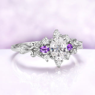 Angled view of the Carmilla amethyst engagement ring showing the leaf carving, scrollwork shoulders and moissanite accents