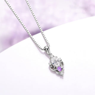 Angled view of the Carmilla moissanite and amethyst pendant showing the tapered bail and carved scroll frame