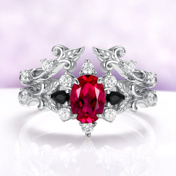 Carmilla ruby and black onyx bridal ring set in sterling silver, oval lab-grown ruby nested inside the leaf and vine enhancer band