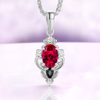 Carmilla lab-grown ruby pendant necklace in sterling silver, oval center with a black onyx pear on a box chain