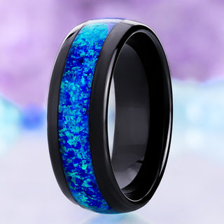 Crushed blue opal men's wedding band in polished black tungsten, 8mm dome with a wide lab-created opal channel