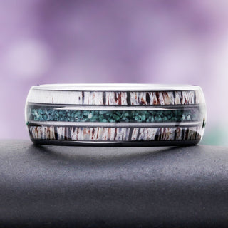 Elk antler wedding band on slate, showing the twin antler inlays and central moss agate channel