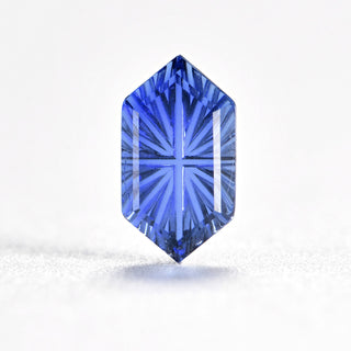 Faelight Cut lab-grown blue sapphire long hexagon 6 x 10 mm loose gemstone, concave starburst facets, on white