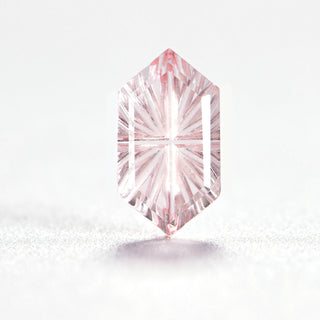 Faelight Cut lab-grown pink sapphire long hexagon 6 x 10 mm loose gemstone, concave starburst facets, on white