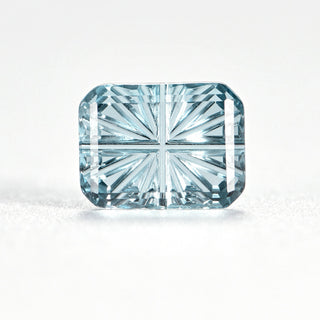 Faelight Cut natural sky blue topaz rectangle 6 x 8 mm loose gemstone, concave starburst facets, on white