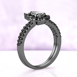 Side profile of the two black ruthenium rings stacked, showing the raised halo frame and matching onyx pavé shanks