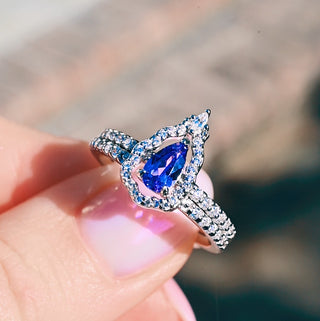 Fairest lavender sapphire set worn on the hand, showing the mirror halo framing the pear stone