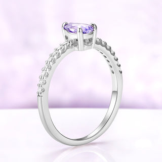 Side profile of the pear sapphire solitaire alone, showing the four-prong setting and tapered pavé shank
