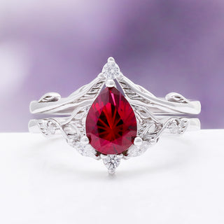 Fireworks Cut Lab-Grown Ruby Engagement Ring Set in Sterling Silver by Aquamarise, a fantasy-cut pear ruby with vine detailing on a rhodium-finished band.