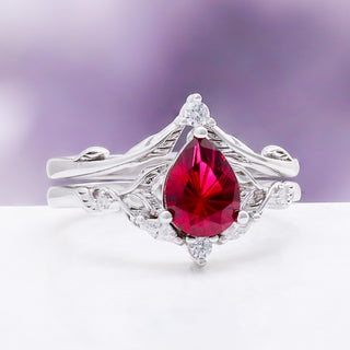 Fireworks Cut Lab-Grown Ruby Engagement Ring Set in Sterling Silver by Aquamarise, showing the fantasy-cut ruby and marquise accent band.