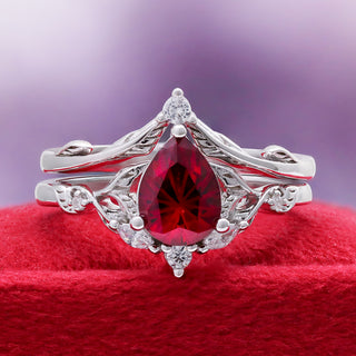 Fireworks Cut Lab-Grown Ruby Engagement Ring Set in Sterling Silver by Aquamarise, styled on red velvet to highlight the ruby centre.