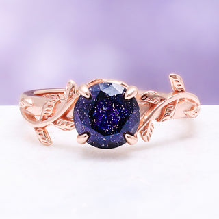 Galaxy sandstone leaf ring — round blue goldstone in a 14K rose gold vermeil leaf and vine setting