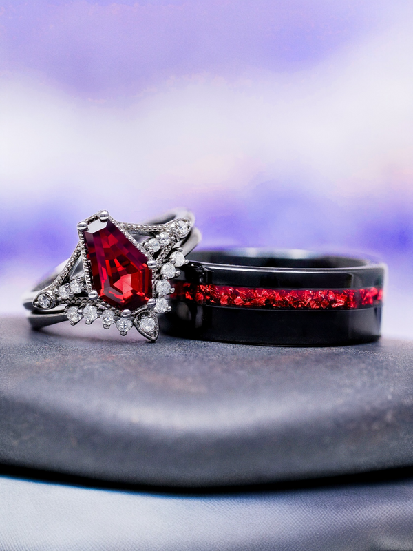 Two rings with red gemstones on a gray surface with a purple gradient background