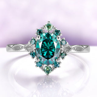 Green Moissanite Vintage Engagement Ring in 14K White Gold by Aquamarise Gold, featuring an oval green moissanite center with intricate nature-inspired halo and delicate band details.