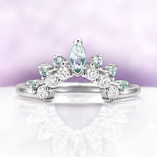 Green Sapphire Marquise Tiara Contour Ring in Sterling Silver by Aquamarise, featuring marquise and round stones with a delicate tiara-inspired design on a reflective white surface.