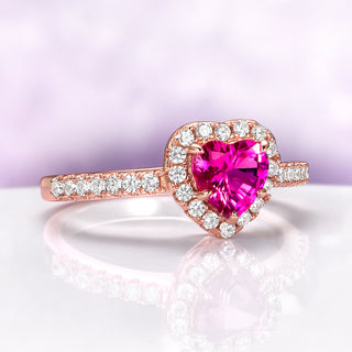 Heart Cut Ruby Promise Ring in 14K Rose Gold Vermeil by Aquamarise, featuring a vibrant heart-shaped ruby center with a diamond halo and pavé accents on a rose gold vermeil band.