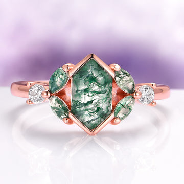 Hexagon Moss Agate Leaf Engagement Ring in 14K Solid Rose Gold by Aquamarise Gold, featuring a hexagon-cut green moss agate center stone with leaf-shaped moss agate accents and sparkling diamonds on a polished rose gold band.