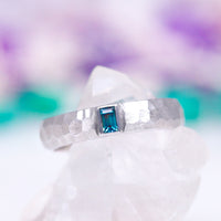 Alexandrite Hammered Wedding Band in 14K White Gold (5.5mm) by Aquamarise Gold featuring a textured hammered finish and a rectangular blue-green alexandrite gemstone, part of Solid Gold Engagement Rings, Men's and Women’s Wedding Bands, and June Birthstone Jewelry collections.