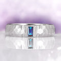 Alexandrite Hammered Wedding Band in 14K White Gold (5.5mm) by Aquamarise Gold featuring a unique hammered texture and a central emerald-cut alexandrite stone with a polished brushed finish, part of Men's and Women’s Wedding Bands collections.