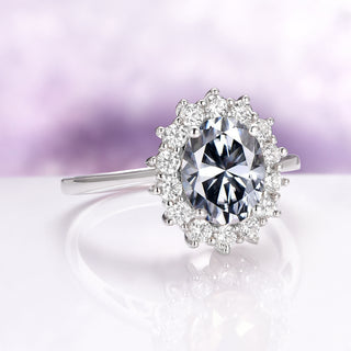 Diana Simulated Gray Diamond Ring in Sterling Silver by Aquamarise featuring an oval gray simulated diamond surrounded by a halo of white stones on a slender silver band.
