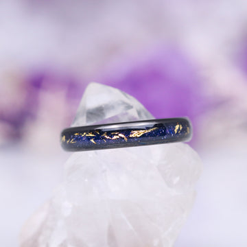 Stardust Couples Ring Set by Aquamarise featuring a black finish band with shimmering blue and gold flecks, inspired by celestial themes, part of Matching Couples' Rings and Best Selling Jewelry collections.