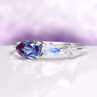 Alexandrite & Moonstone Dainty Engagement Ring in 14K White Gold featuring a pear-shaped alexandrite, marquise moonstone, and small diamond accent in a delicate band design.