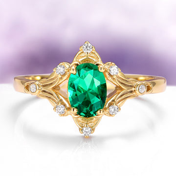 Delicate Maeve Emerald Couples Ring Set featuring a vibrant green emerald center stone with sparkling diamonds set in 14k yellow gold, crafted by Aquamarise, a nature-inspired matching couples ring.