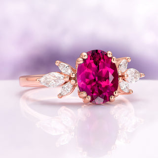 Eva Oval Cut Lab Grown Ruby Engagement Ring in 14K Rose Gold Vermeil by Aquamarise featuring an oval ruby with marquise and pear-shaped simulated diamond accents in a vintage lotus motif.