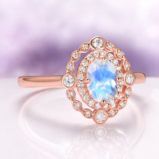 Valentina Rainbow Moonstone Engagement Ring in 14K Solid Rose Gold by Aquamarise Gold featuring an oval rainbow moonstone accented with intricate diamond details on a vintage-inspired band.