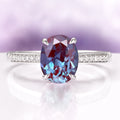 Ava Oval Cut Alexandrite Engagement Ring in 14K White Gold by Aquamarise Gold featuring a vibrant oval alexandrite center and pavé diamond accents on a polished white gold band.
