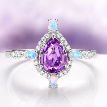 Natural Amethyst & Fire Opal Engagement Ring in 14K White Gold by Aquamarise Gold featuring a pear-shaped amethyst center with opal and diamond accents on a delicate white gold band.