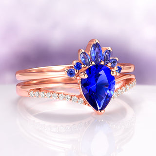 Dakota Teardrop Blue Sapphire Ring Set in 14K Rose Gold Vermeil by Aquamarise, featuring a vibrant teardrop sapphire with accent stones and diamond pavé on rose gold vermeil bands.