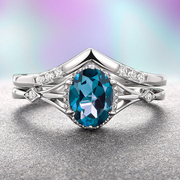 Celtic London Blue Topaz Ring Set- 14K White Gold by Aquamarise Gold, featuring a deep blue oval London blue topaz with delicate diamond accents on an intricately designed white gold band, part of Solid Gold Engagement Rings and November Birthstone collections.